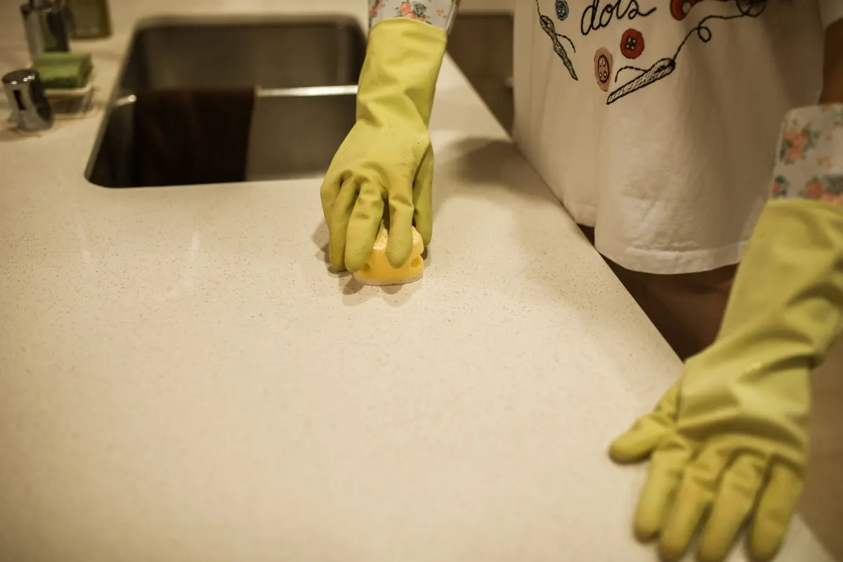 Professional cleaner wiping a kitchen counter — Wexi Cleaning Lawrenceville GA